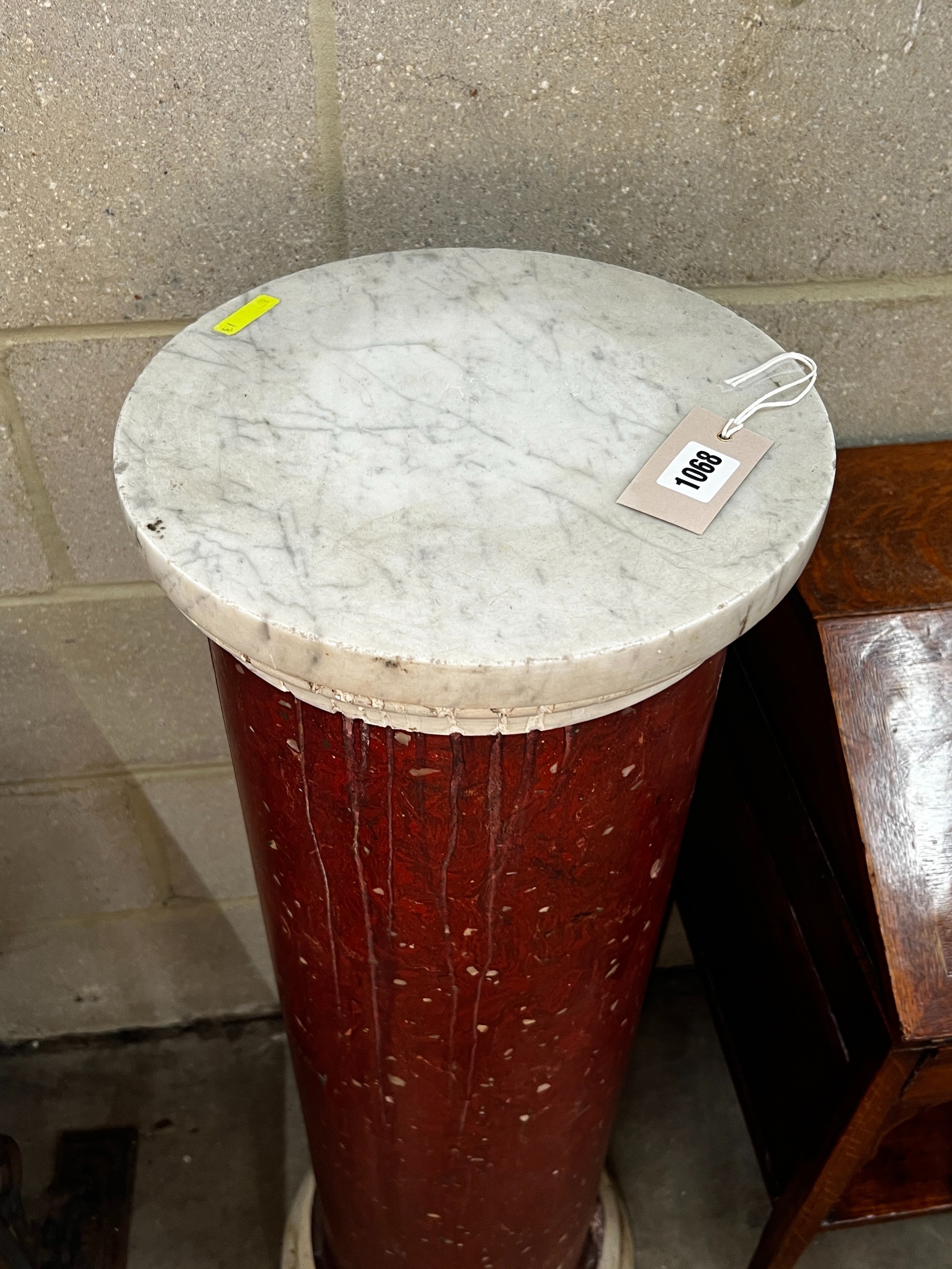 A faux porphyry column with circular marble top, height 104cm